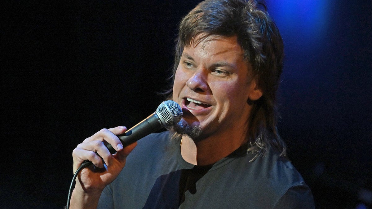 Theo Von with a microphone