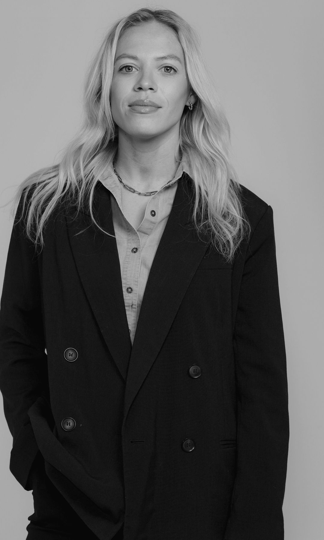 Hello! Fashion's Fashion & Lifestyle writer Lauren Ramsay poses for her headshot in a black blazer
